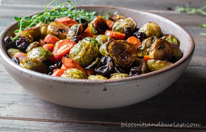 horizontal shot of roasted brussel sprouts in pottery bowl