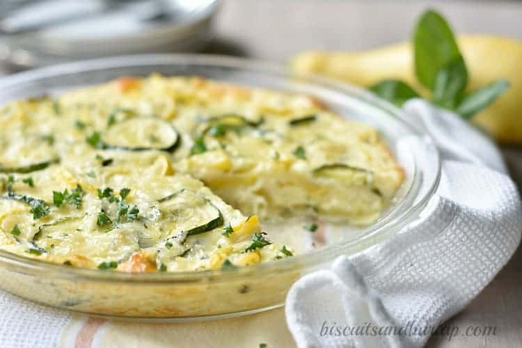 squash pie sprinkled with fresh herbs in a glass pie dish