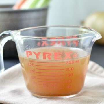 beef stock in measuring cup.