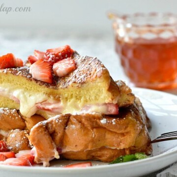 french toast on plate with syrup behind