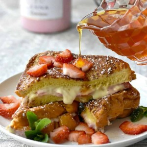 syrup being poured over stuffed french toast.