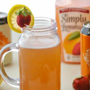 strawberry shandy in jar with fruit.