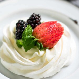 mini pavlova with berries on top.