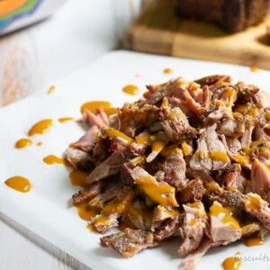 barbecue pork on a charcoal grill from BiscuitsandBurlap.com