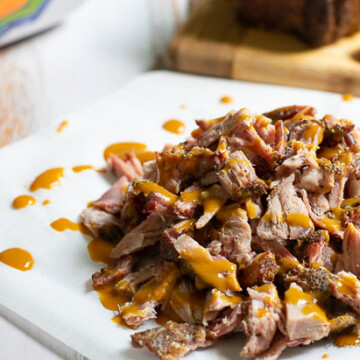 barbecue pork on a charcoal grill from BiscuitsandBurlap.com