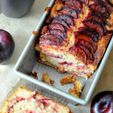 plum coffee cake in pan with slice out.
