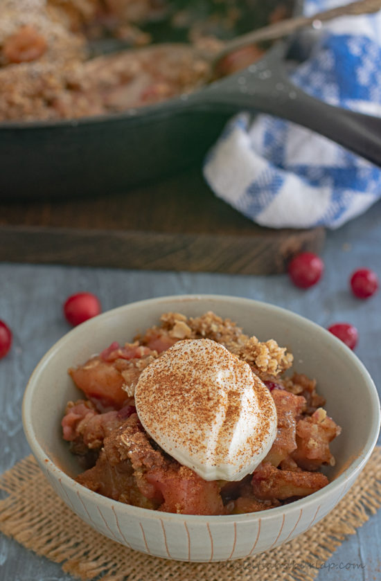 Apple Crisp with Cranberries is the perfect fall dessert baked in an iron skillet.