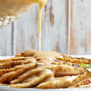 turkey slices with gravy being poured.