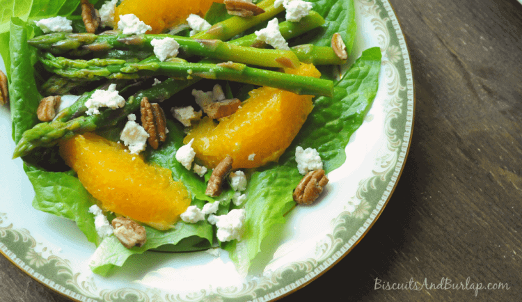 Salad on plate with oranges and goat cheese