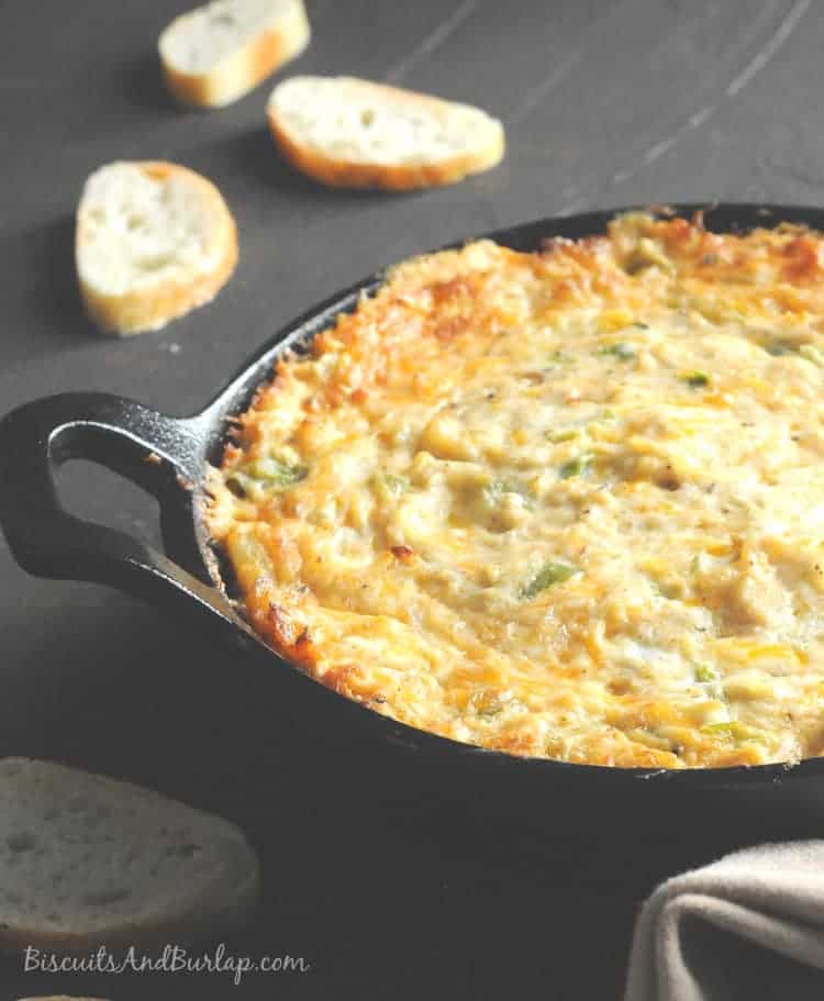 Crab dip in a cast iron skillet on a dark background