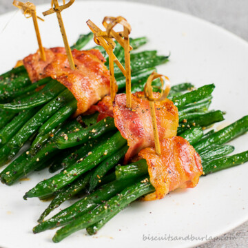 green bean bundles on white plate.