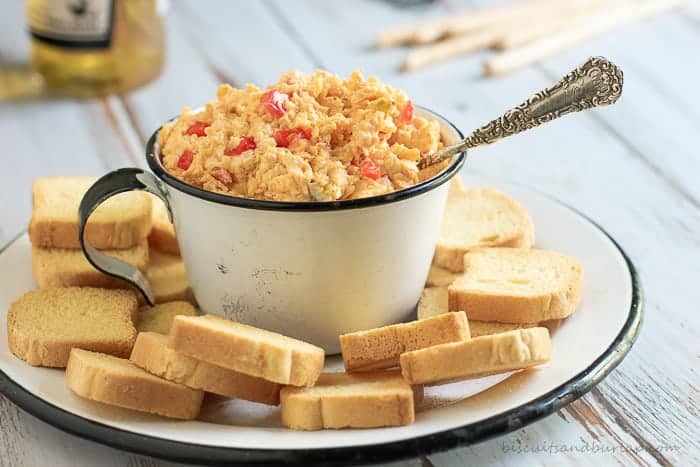 Homemade Pimento Cheese with a smoky twist and a spicy kick is perfect for snacks and sandwiches on its own. Use it in any recipe calling for Pimento Cheese as an ingredient to take your dish up a notch or two.