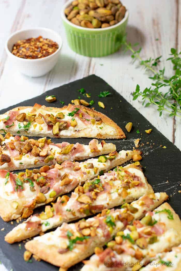 Flatbread appetizers with a unique blend of flavors from pistachios, burrato and proscuitto