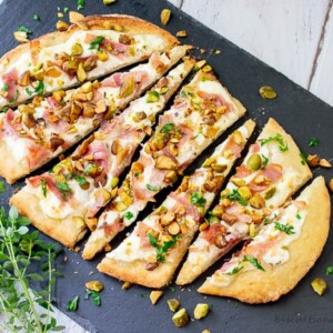Flatbread appetizers with a unique blend of flavors from pistachios, burrato and proscuitto