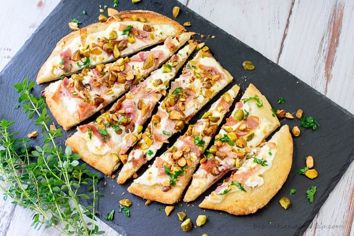 Flatbread appetizers with a unique blend of flavors from pistachios, burrato and proscuitto