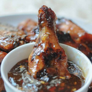 chicken wing dipped in sauce.