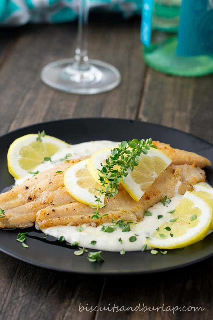 catfish on plate with wine bottle and glass