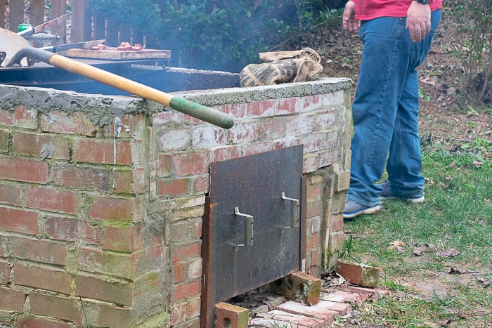 brick fire pit with shovel on top