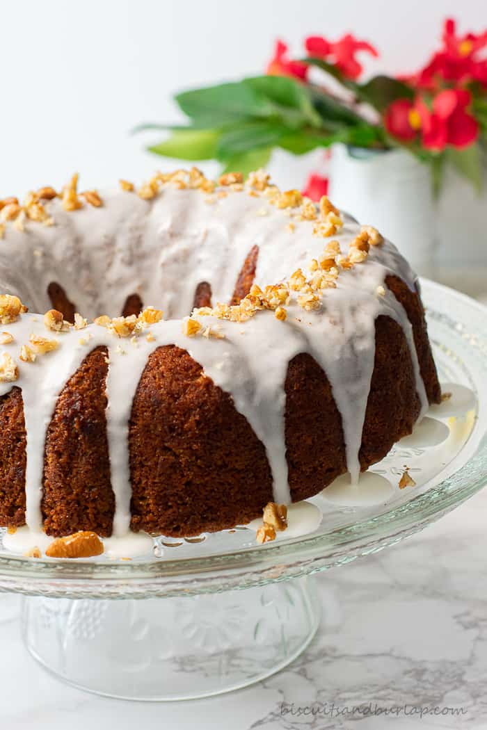 coffee cake on stand with red flowers in background