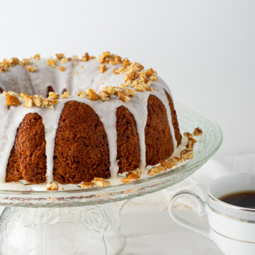 coffee cake on glass stand with coffee.