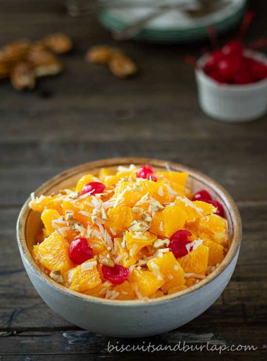 ambrosia in bowl with cherries and pecans behind