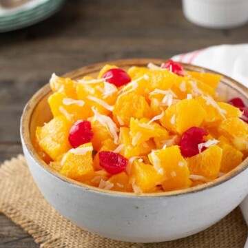 ambrosia in bowl with cherries behind