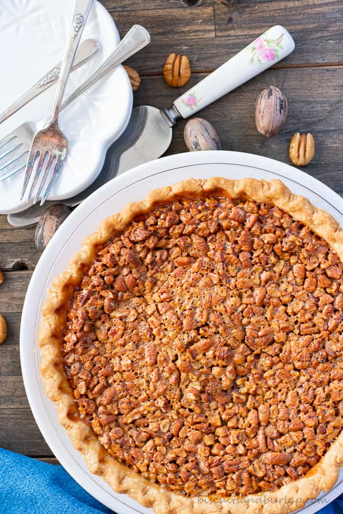 whole pecan pie with plates & forks