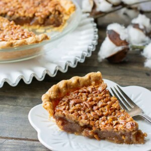 slice of pie with fork and whole pie behind