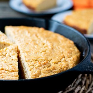 sweet potato cornbread in skillet with slices behind