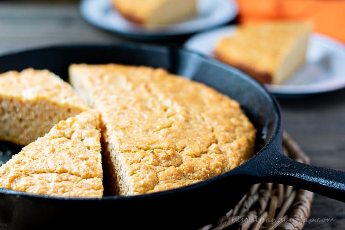 sweet potato cornbread in skillet with slices behind