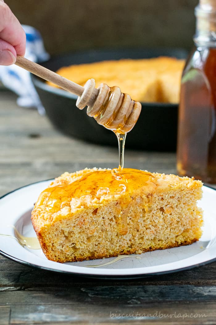 slice of sweet potato cornbread with honey dripping