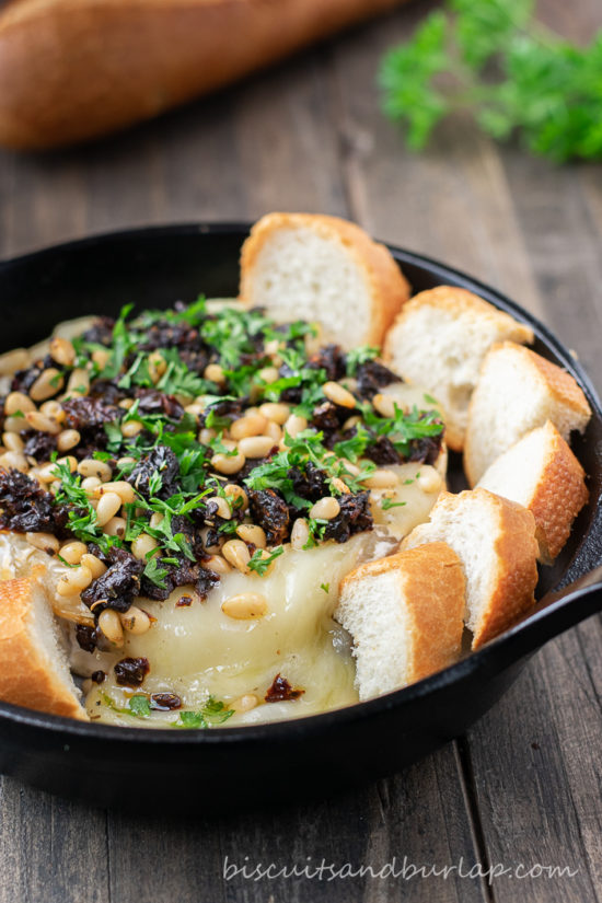 baked brie cheese in small iron skillet