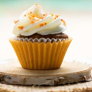 one mini carrot cupcake on coaster