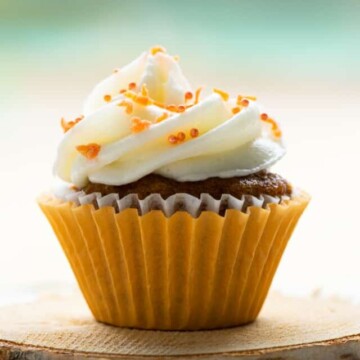 one mini carrot cupcake on coaster