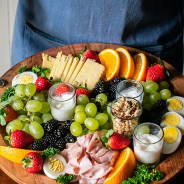 woman holiding a breakfast charcuterie board