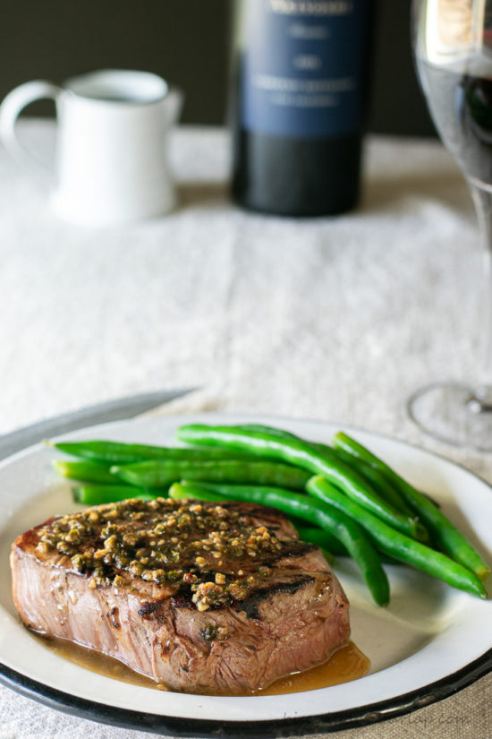 filet mignon sauce over steak on plate