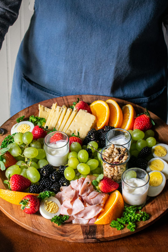 woman holiding a breakfast charcuterie board