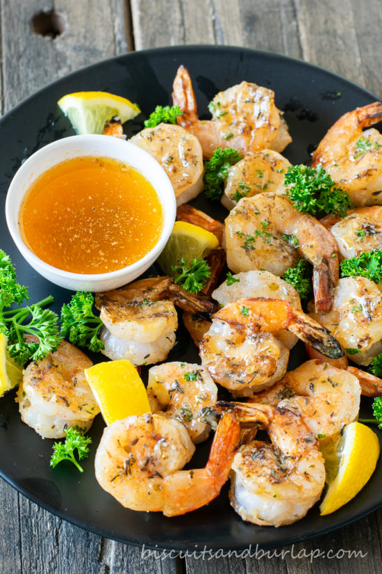 grilled shrimp with lemon on plate with sauce