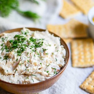 bowl of smoked fish dip with crakcers and lemon