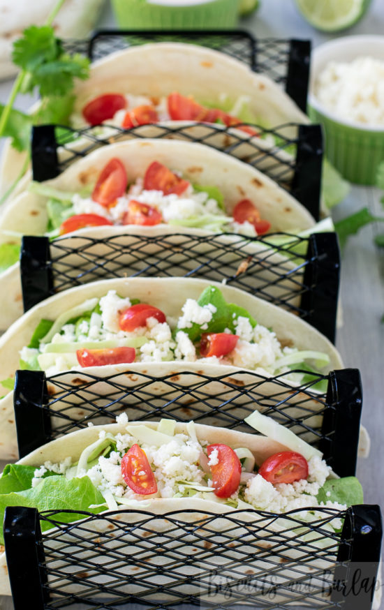 overhead of grilled fish tacos in stand