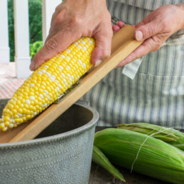 close up of woman making creamed corn.