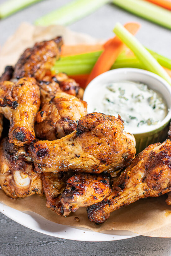 chicken wings on plate with sauce & veggies