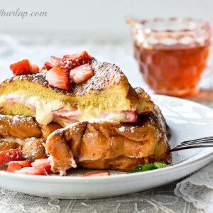 plate of stuffed french toast with syrup behind