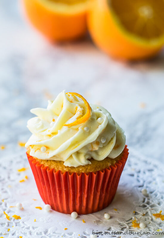 orange cupcake with oranges behind