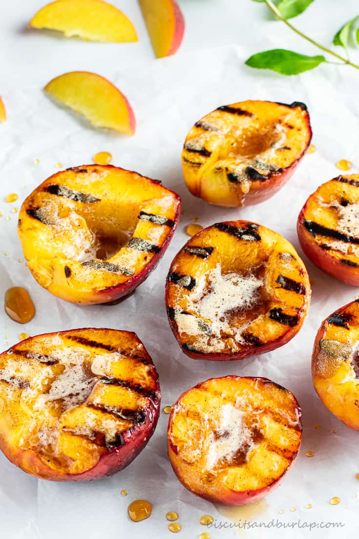 grilled peach halves with slices behind