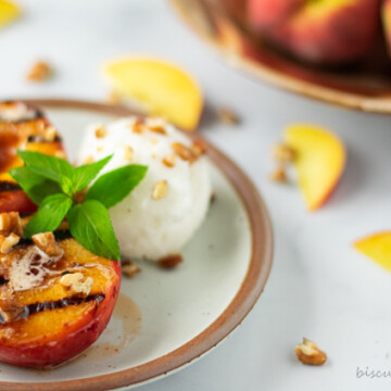 grilled peach haves on plate with ice cream