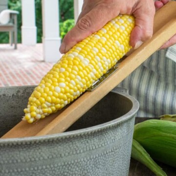 creaming corn into a pan.