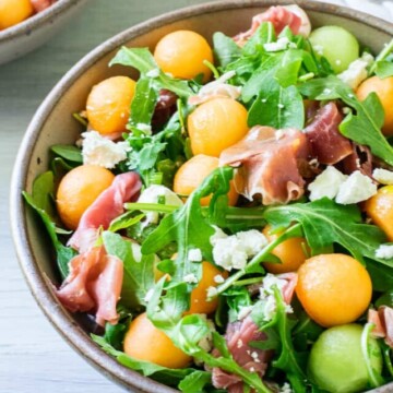 melon salad in bowl with another behind