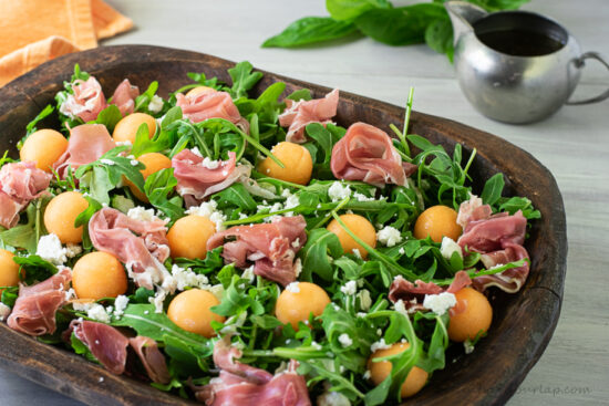 horizontal shot of melon and prosciutto salad