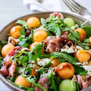 melon and proscuitto salad in bowl.